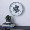 16" X 16" Round Metal Wall Clock With Functioning Gear Center Black/White - Olivia & May -Olivia & May GUEST 764adaf9 1b9b 444e bd24 637c17cc6cdc